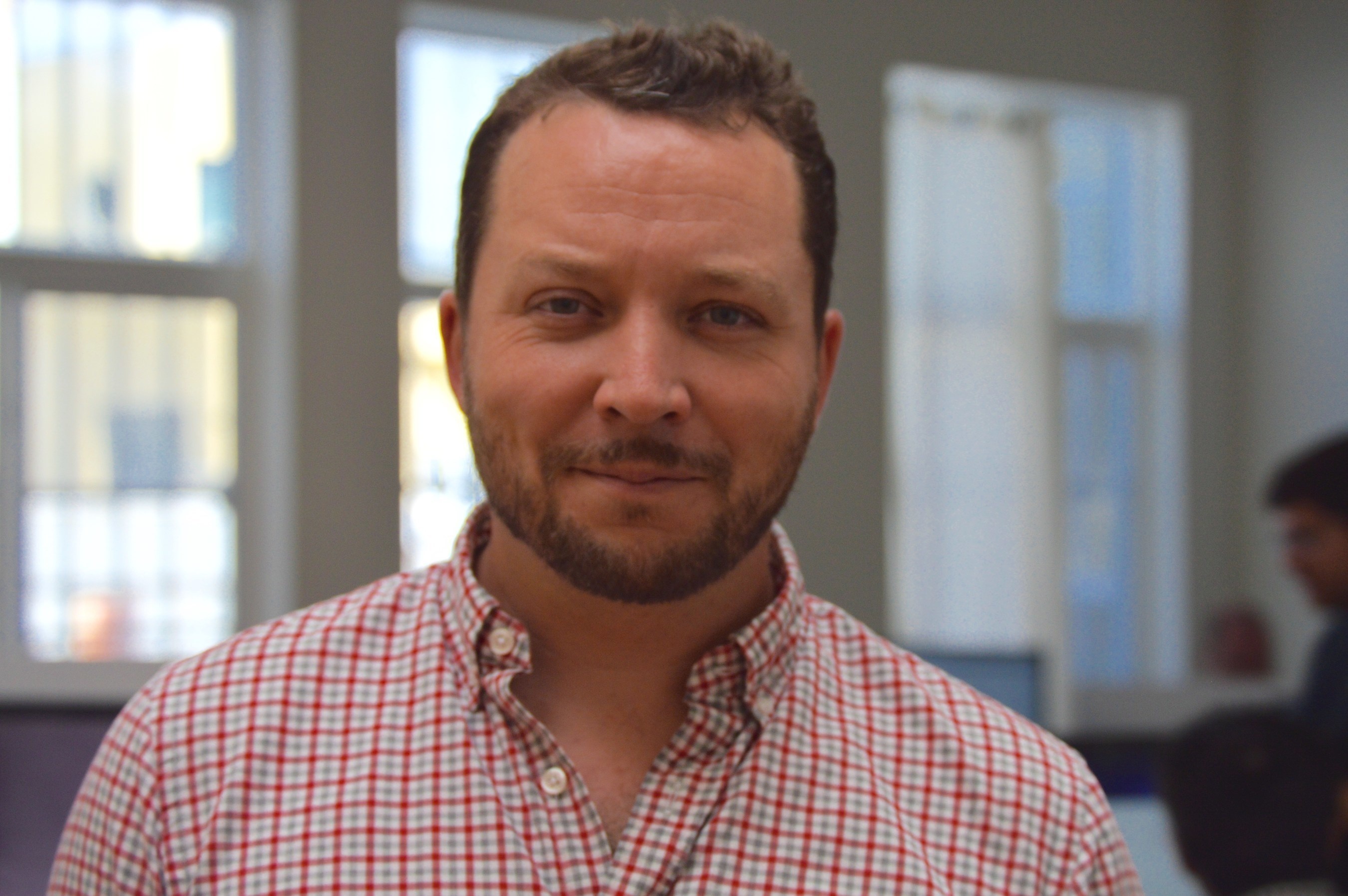 Brendon McQueen in a checked shirt, photographed for Tuition.io’s November 2015 financing announcement