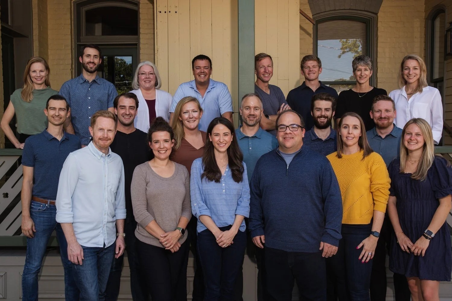 Brent Beshore, in a light blue shirt in the back row, with the Permanent Equity team on a porch