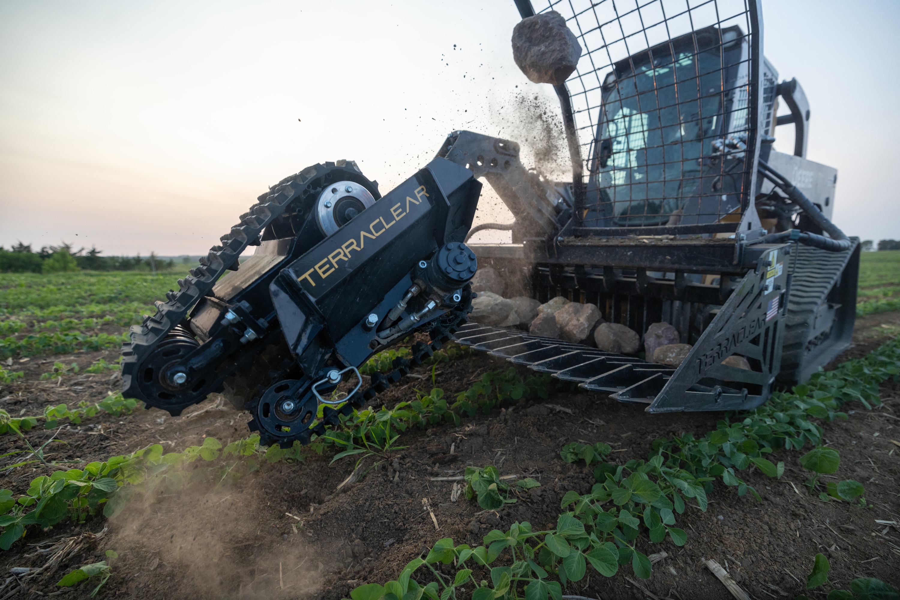 TerraClear TC80 rock picker attached to a loader working in a planted field