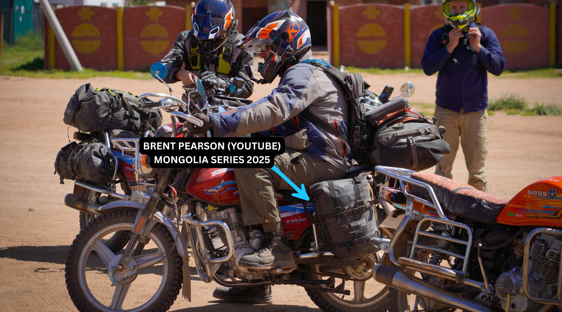 Brent Pearson on a loaded adventure motorcycle with fellow riders, in an image identified by Nomad Moto as his Mongolia series in 2025