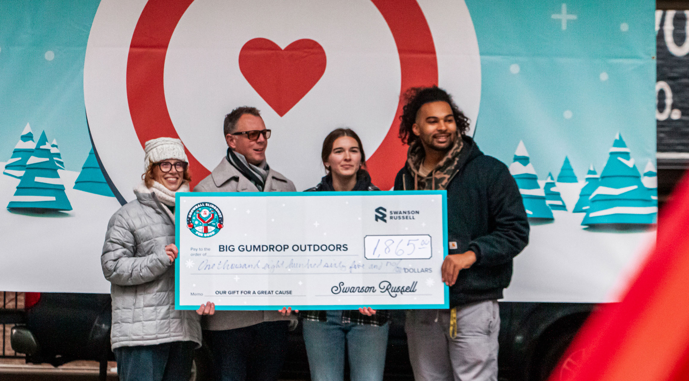Brent Schott and Swanson Russell colleagues presenting a fundraiser check to Big Gumdrop Outdoors