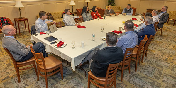Powell leaders and Miami University officials in discussion around a conference table