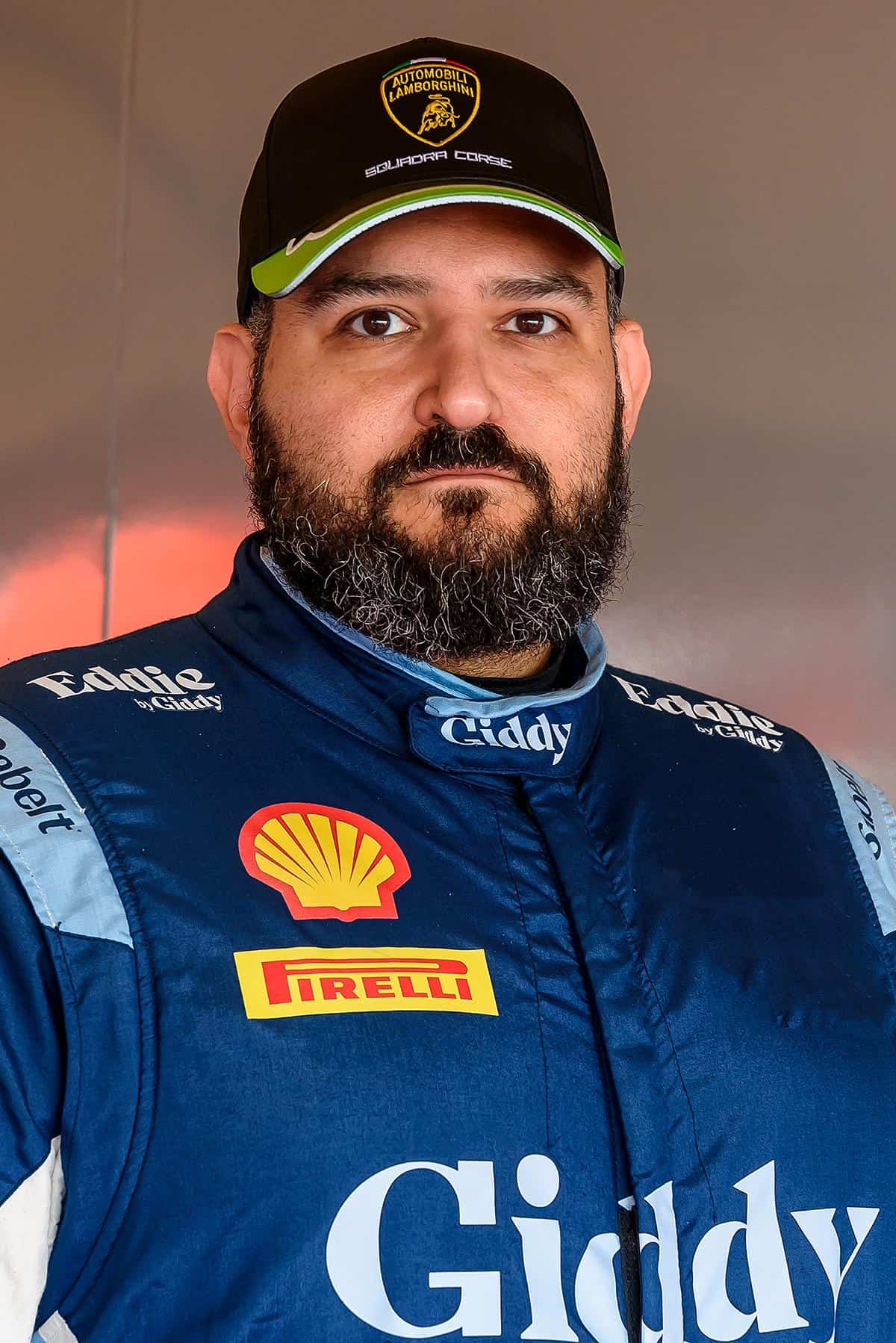 Brett Jacobson wearing his blue Giddy racing suit and a Lamborghini cap