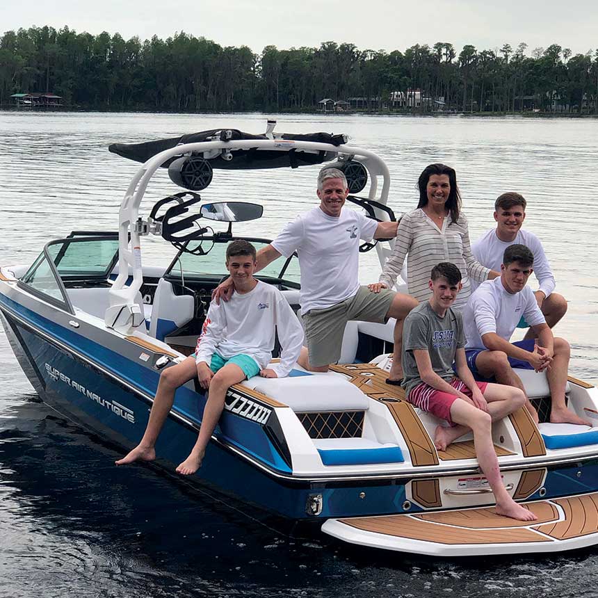 Brett McGill aboard a boat with his wife Vicki and their four sons
