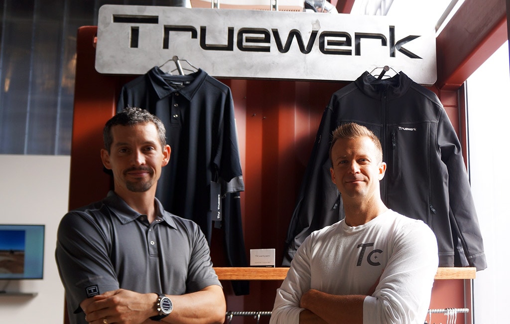 Brian Ciciora, left, beside Bryce Ballew under a TRUEWERK display at Tradecraft Industries in 2017