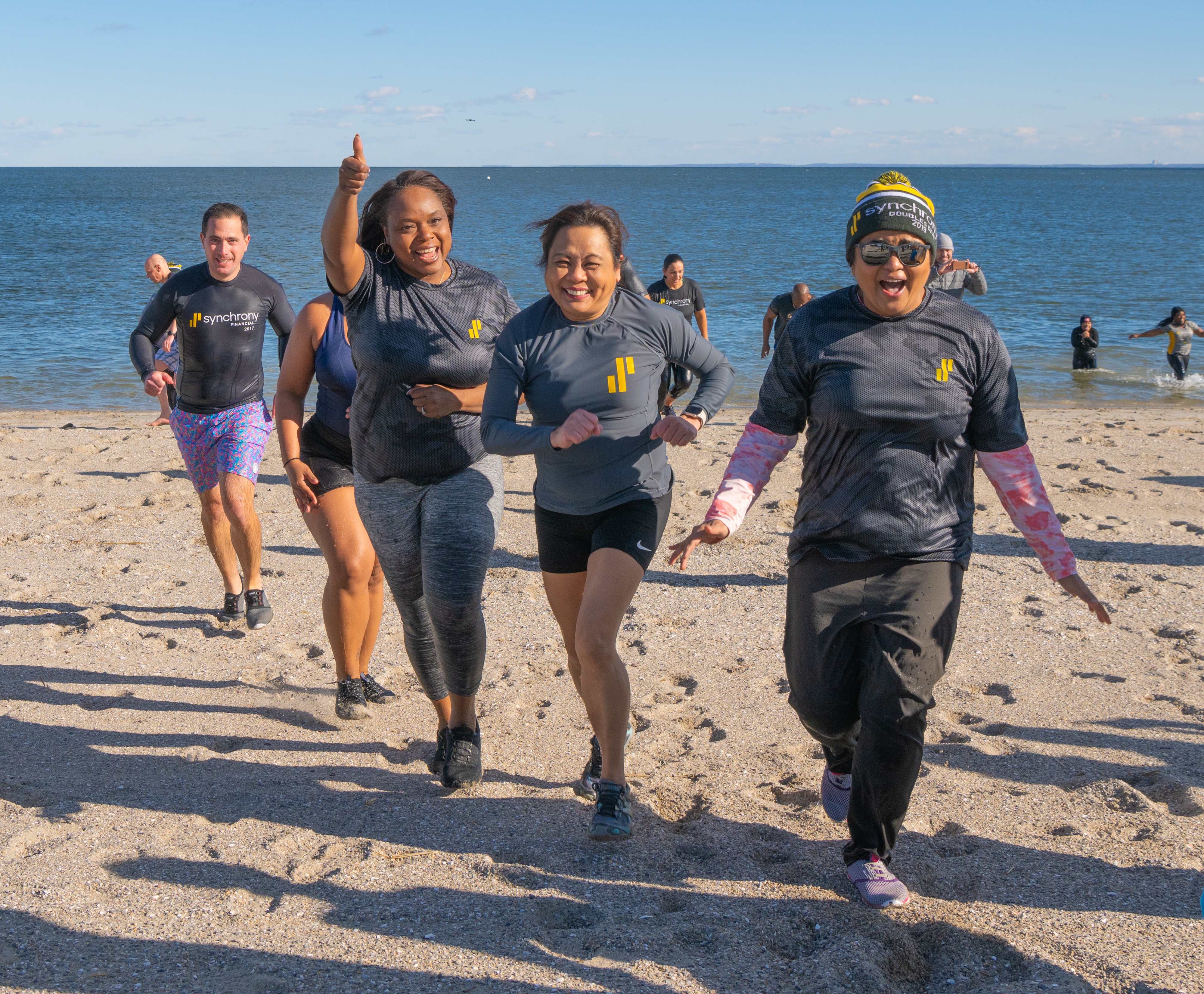 Synchrony employees returning to Compo Beach after the 2024 charity polar plunge