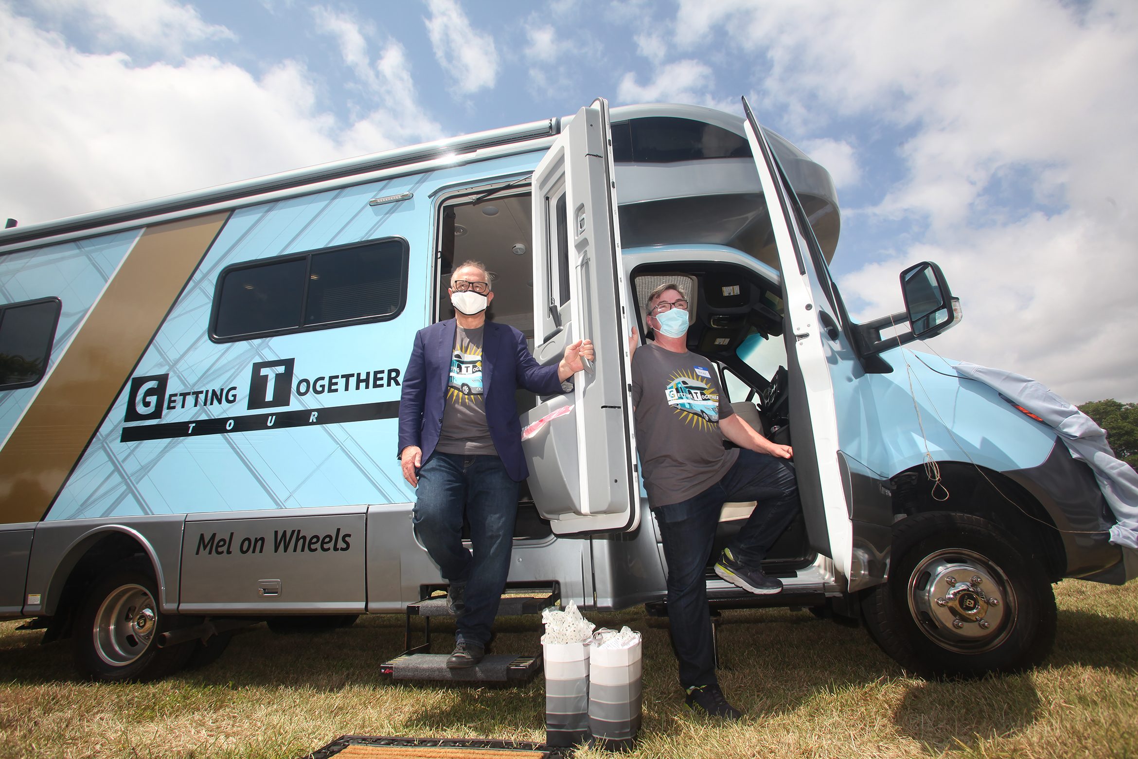 Richard Rosenbaum and Brian Duffy standing in the doorways of the Mel on Wheels recreational vehicle