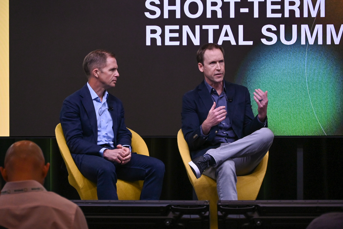 Brian Egan, seated at right, speaking alongside Henrik Kjellberg at the Skift Short-Term Rental Summit