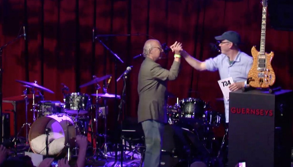 Brian Halligan, at right, beside Jerry Garcia’s Wolf guitar at the 2017 charity auction