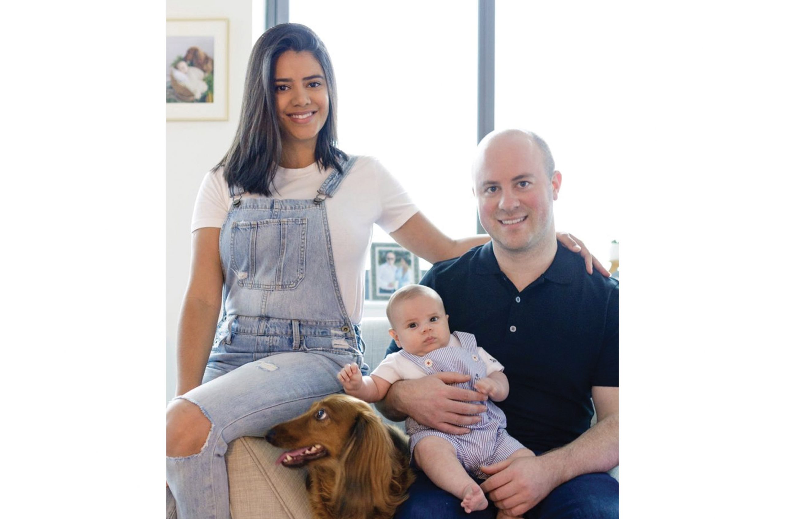 Brian Hardecker seated with his family, a baby and a dog, in a photograph published in 2021