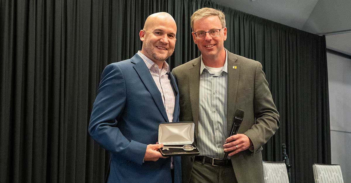 Brian Liddell, left, accepts a key to South Bend from Mayor James Mueller