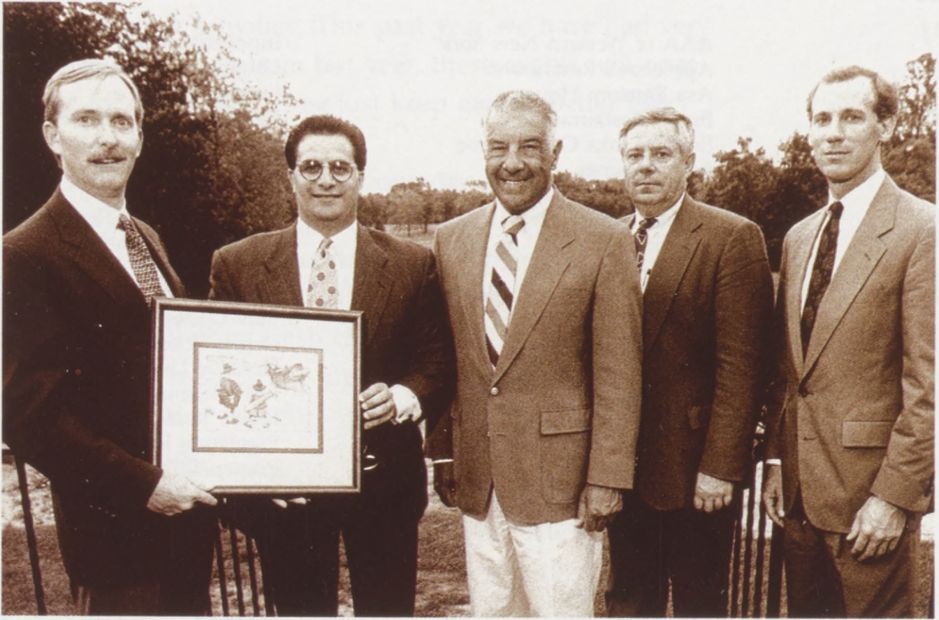 Brian Lipke, at left, receiving a print with Daemen Golf Classic committee colleagues in 1993
