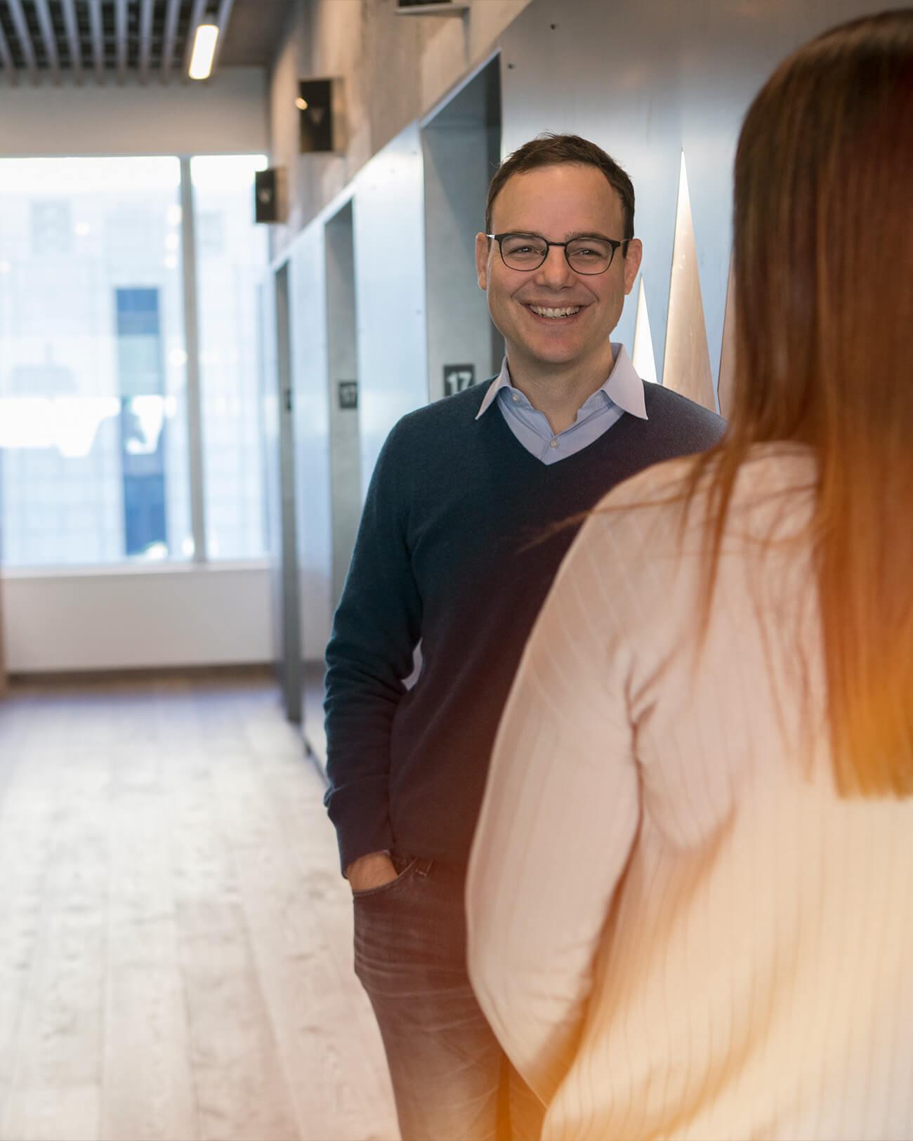 Brian McGuigan smiling during a conversation in Laird Norton’s Seattle office