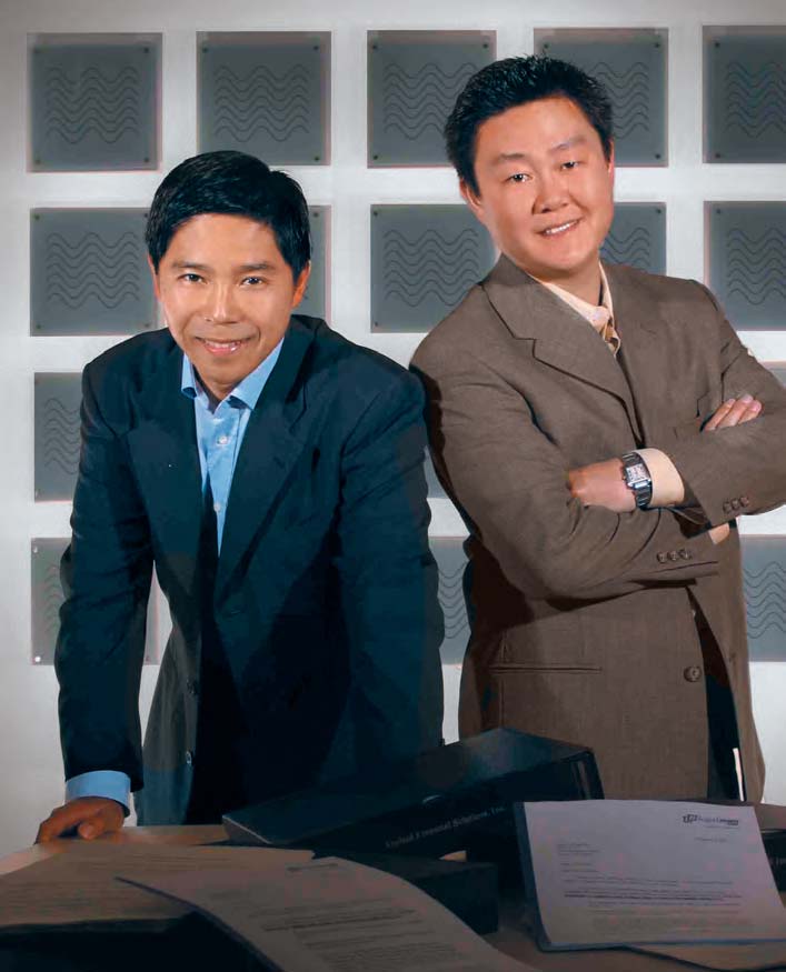 Brian Liu on the left and Brian Lee on the right, leaning over a table of legal documents