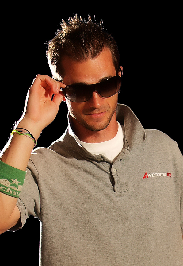 An archival photograph of Brian Raney wearing sunglasses and an Awesome Inc polo shirt