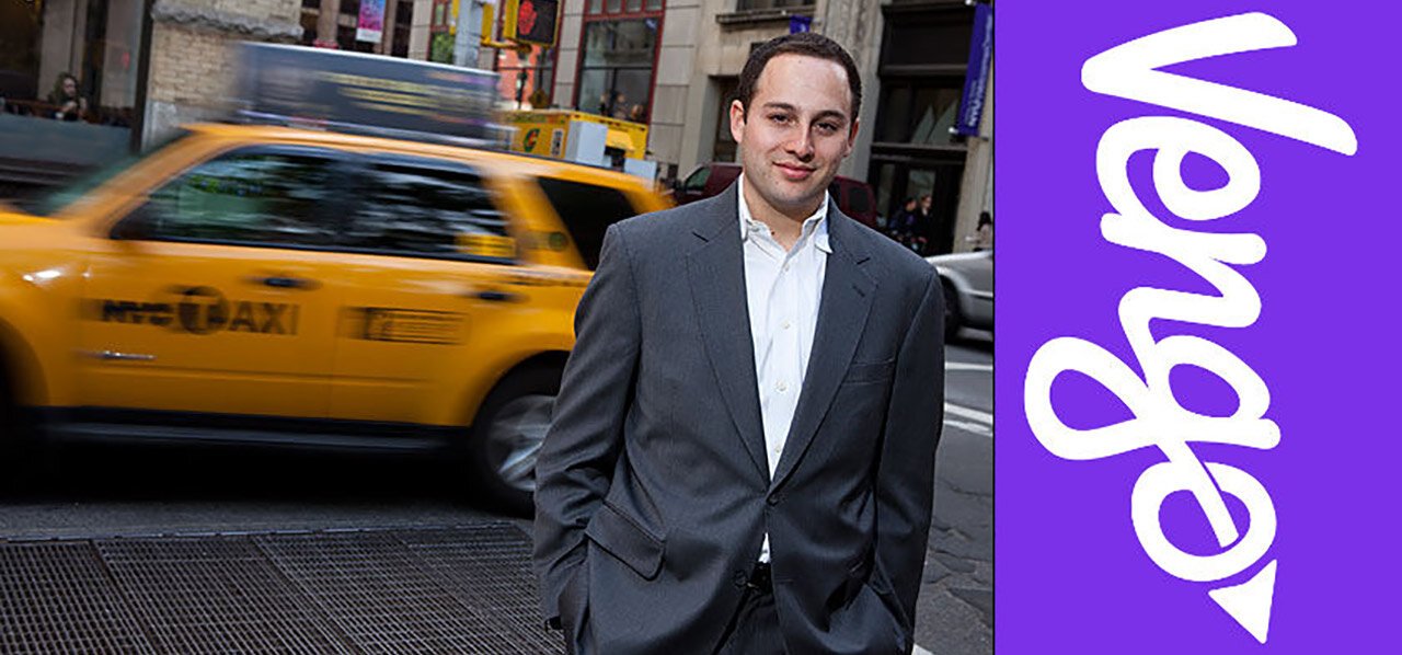 Brian Shimmerlik on a New York sidewalk beside a passing yellow taxi