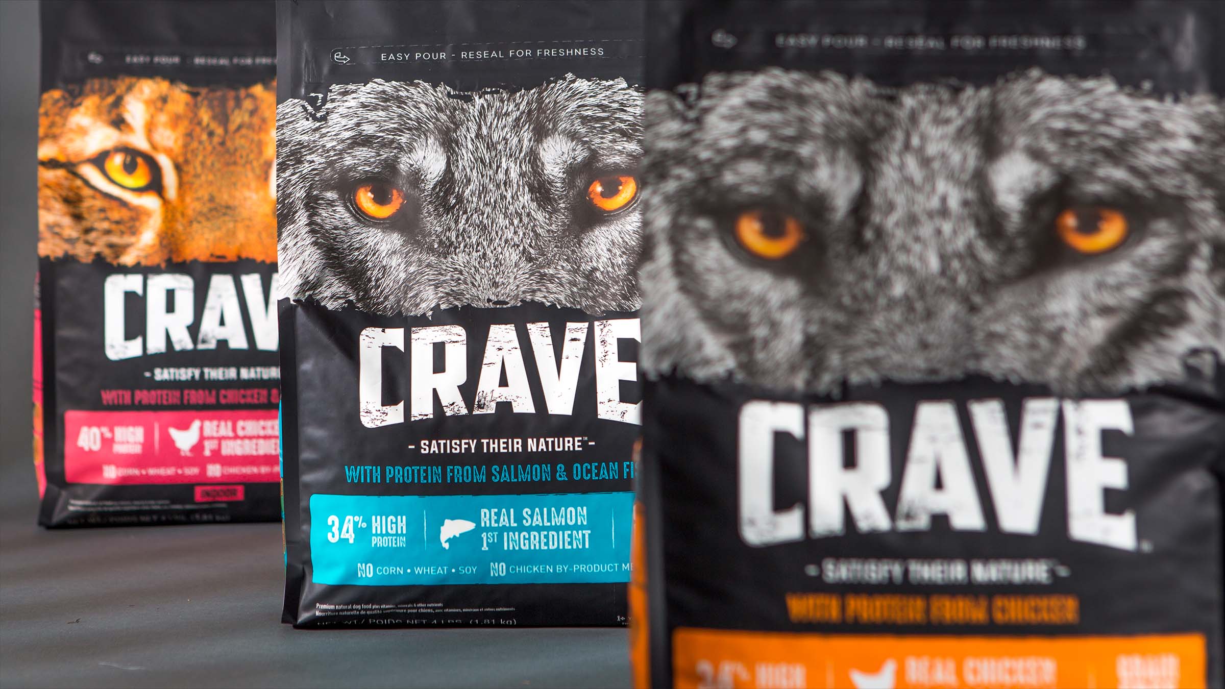 CRAVE pet food packaging featuring large amber wolf eyes