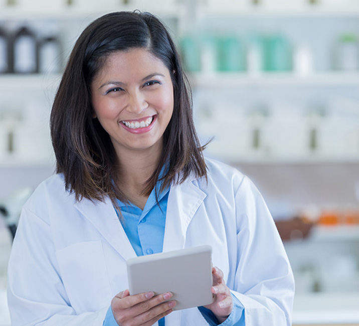 Brightree promotional photograph of a pharmacist using a mobile device