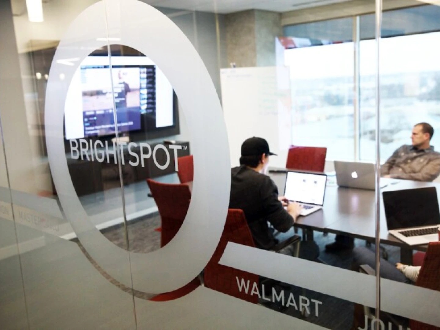 Brightspot colleagues gathered around a meeting table in the Reston office