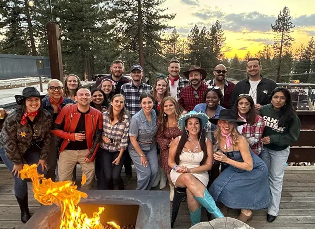 The Brisk team gathered around an outdoor fire pit