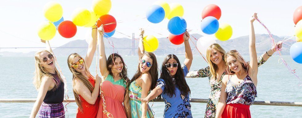 Brit + Co team members holding colorful balloons by the San Francisco waterfront
