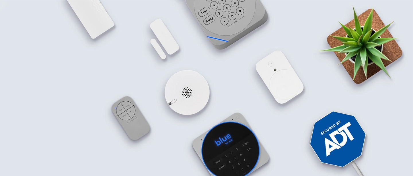 Blue by ADT home-security devices arranged on a pale surface