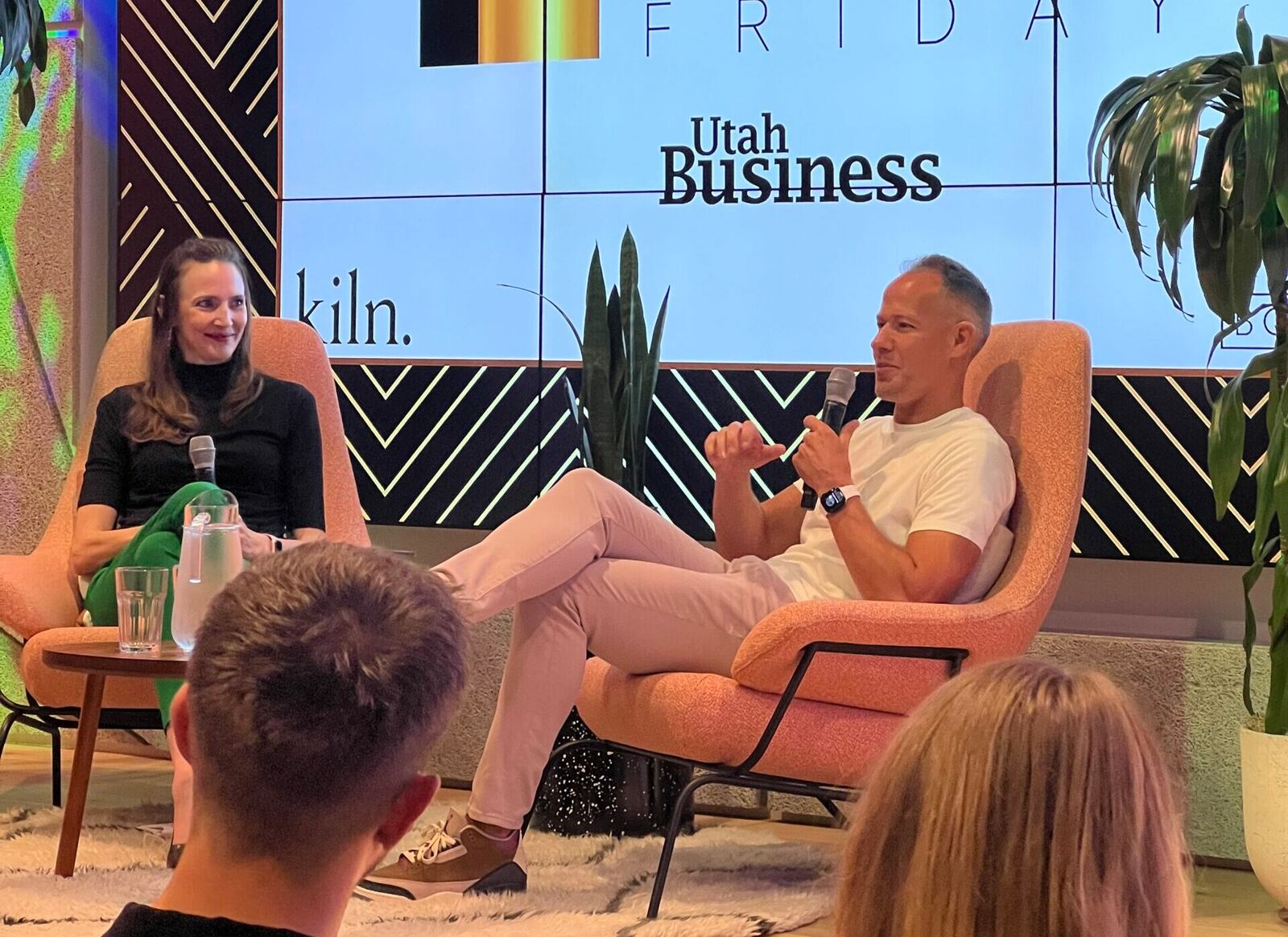 Brock Blake speaking with an interviewer onstage at a Utah Business Founder Friday event
