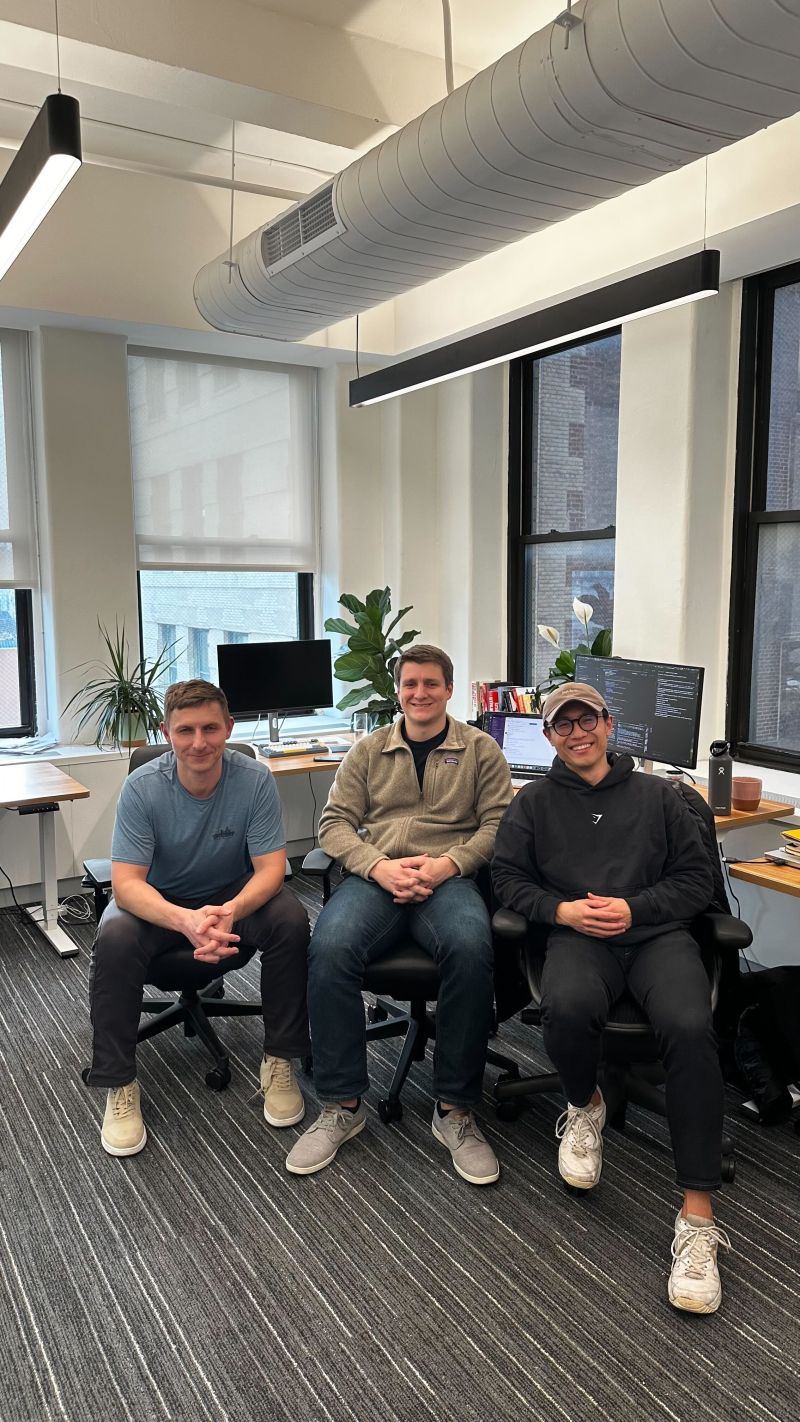 Brodie Marshall seated at center with two colleagues in a New York office