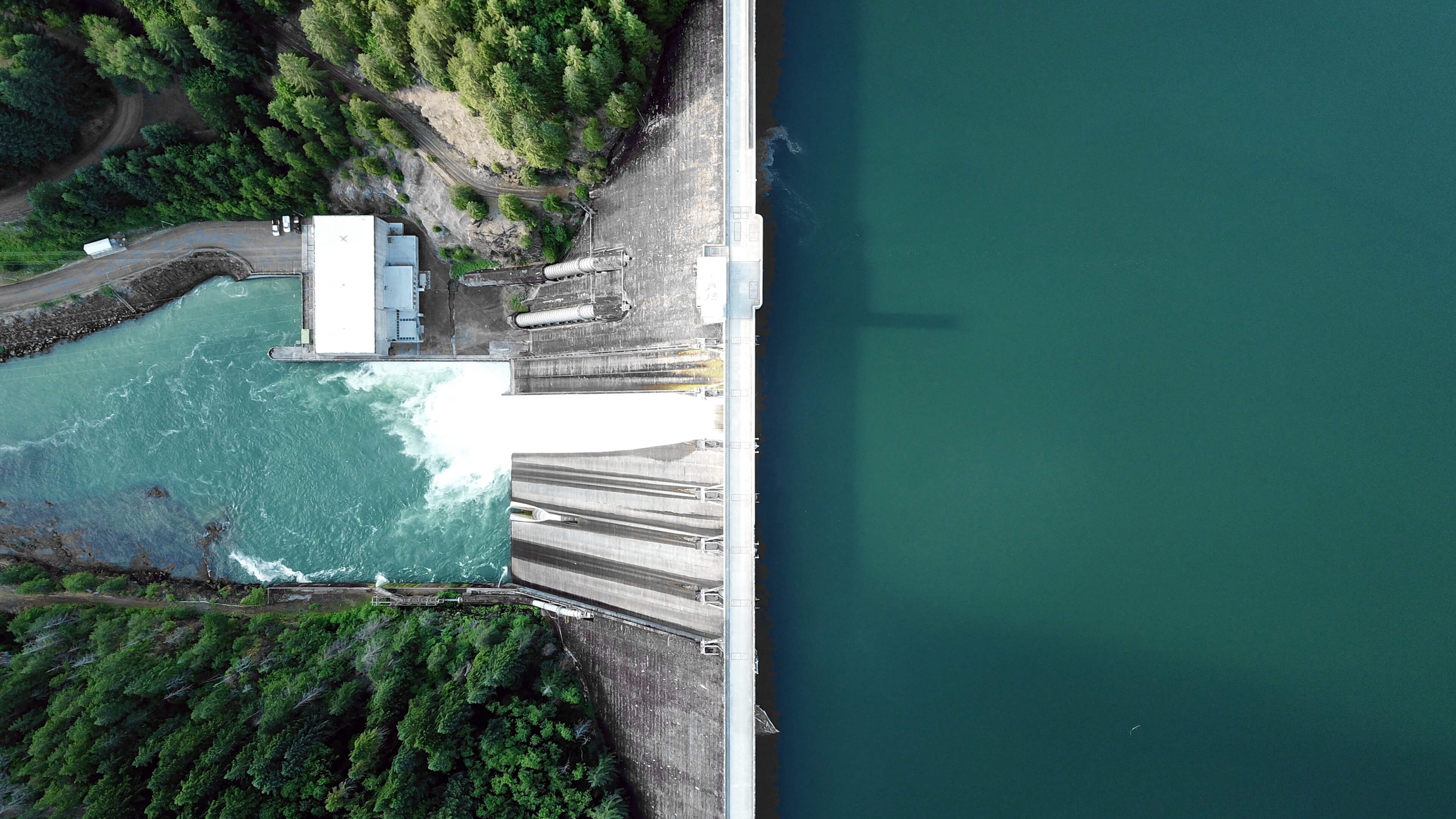 Aerial view of a hydroelectric dam and turquoise water