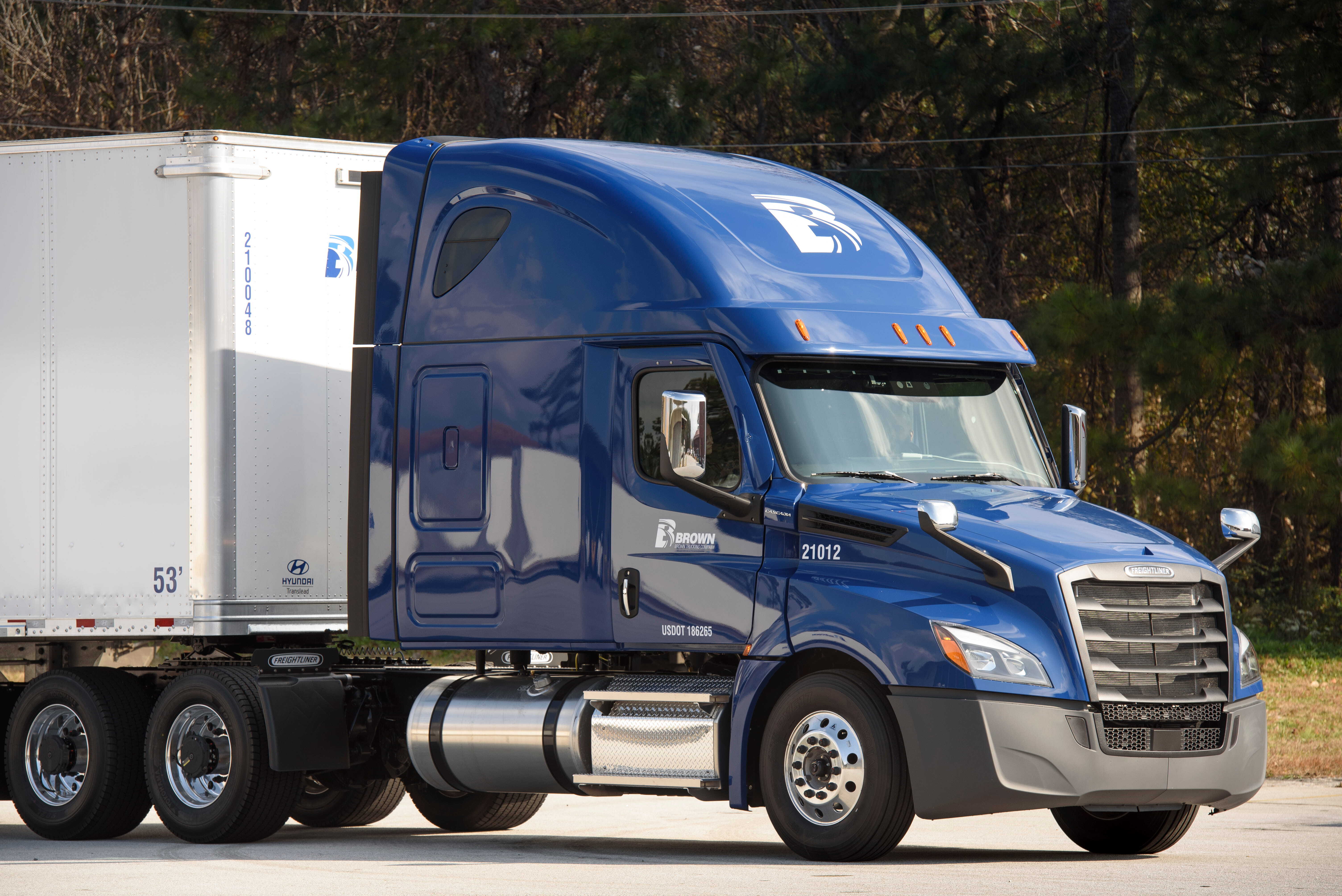 Blue Brown Trucking tractor attached to a white trailer