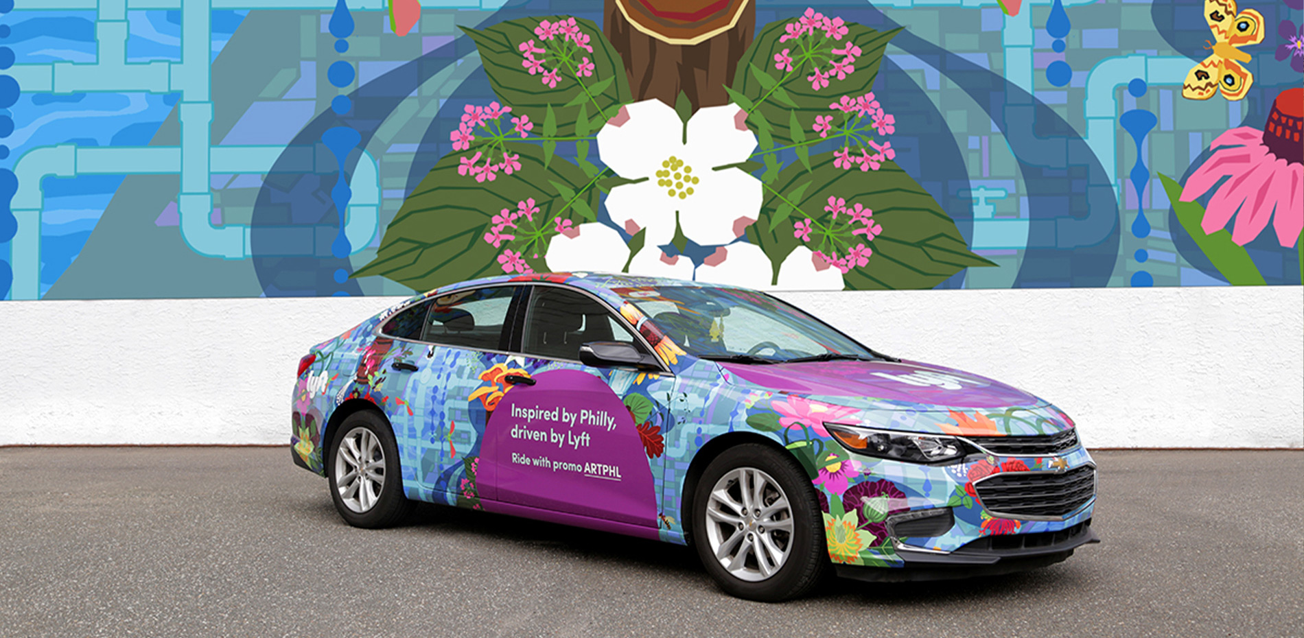 A Lyft car wrapped in colorful Philadelphia mural artwork