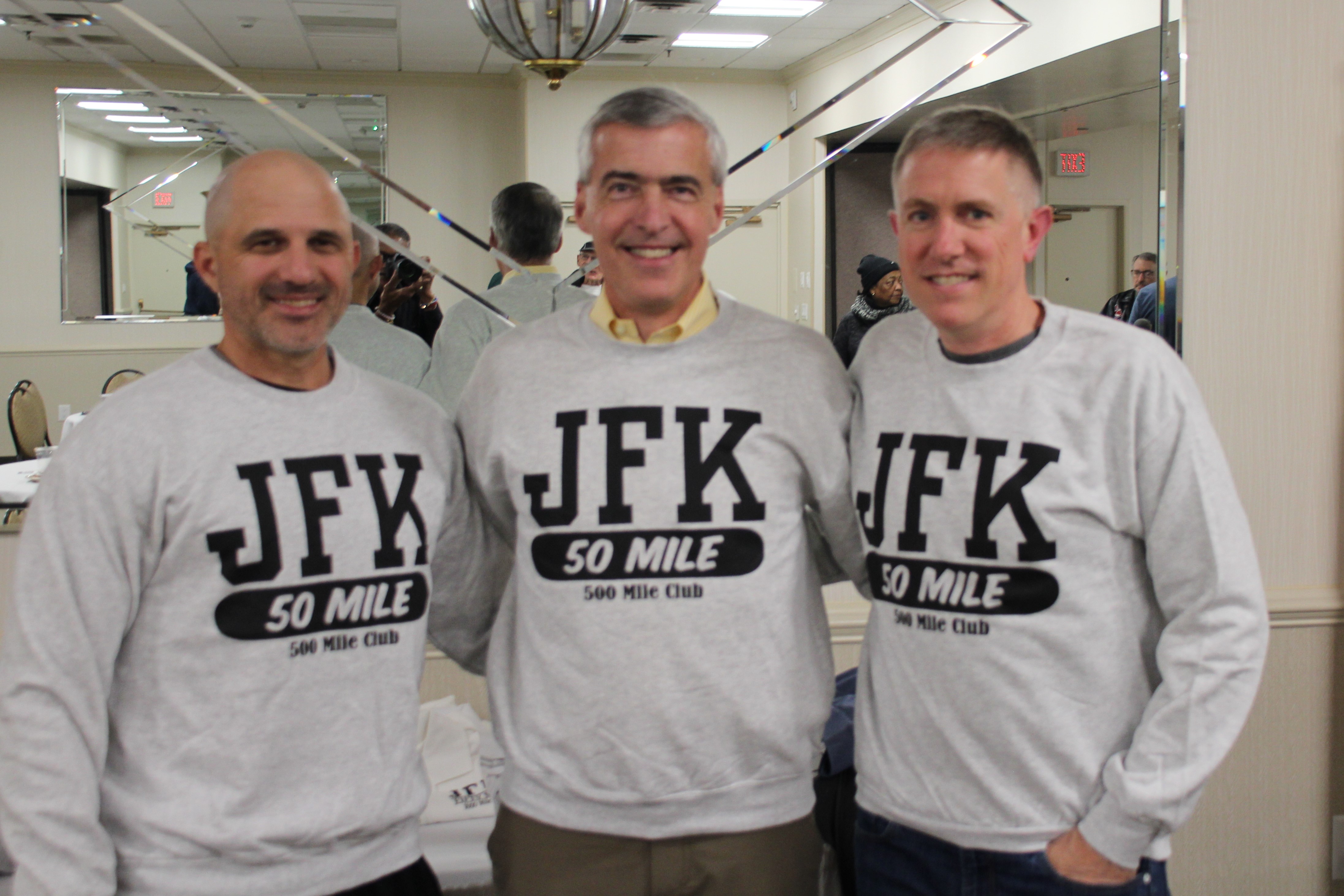 Bruce Caswell, center, with his two running partners wearing JFK 50 Mile 500-Mile Club sweatshirts