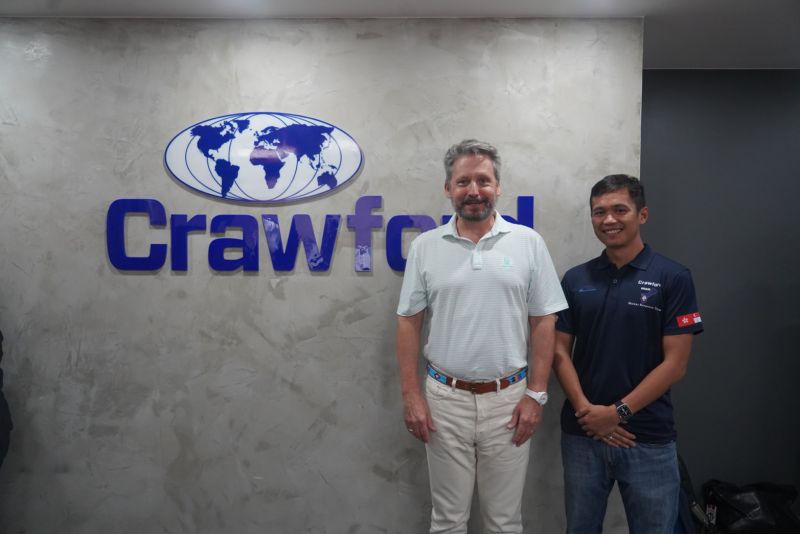 Bruce Swain in a pale polo shirt with a colleague at Crawford’s Makati office