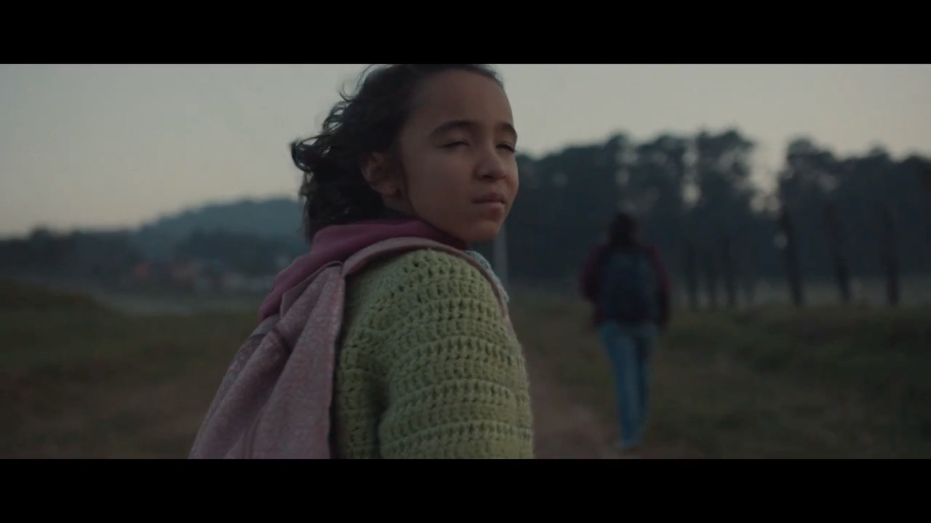A mother and young daughter walk along a dusty road in Brunner's 84 Lumber campaign