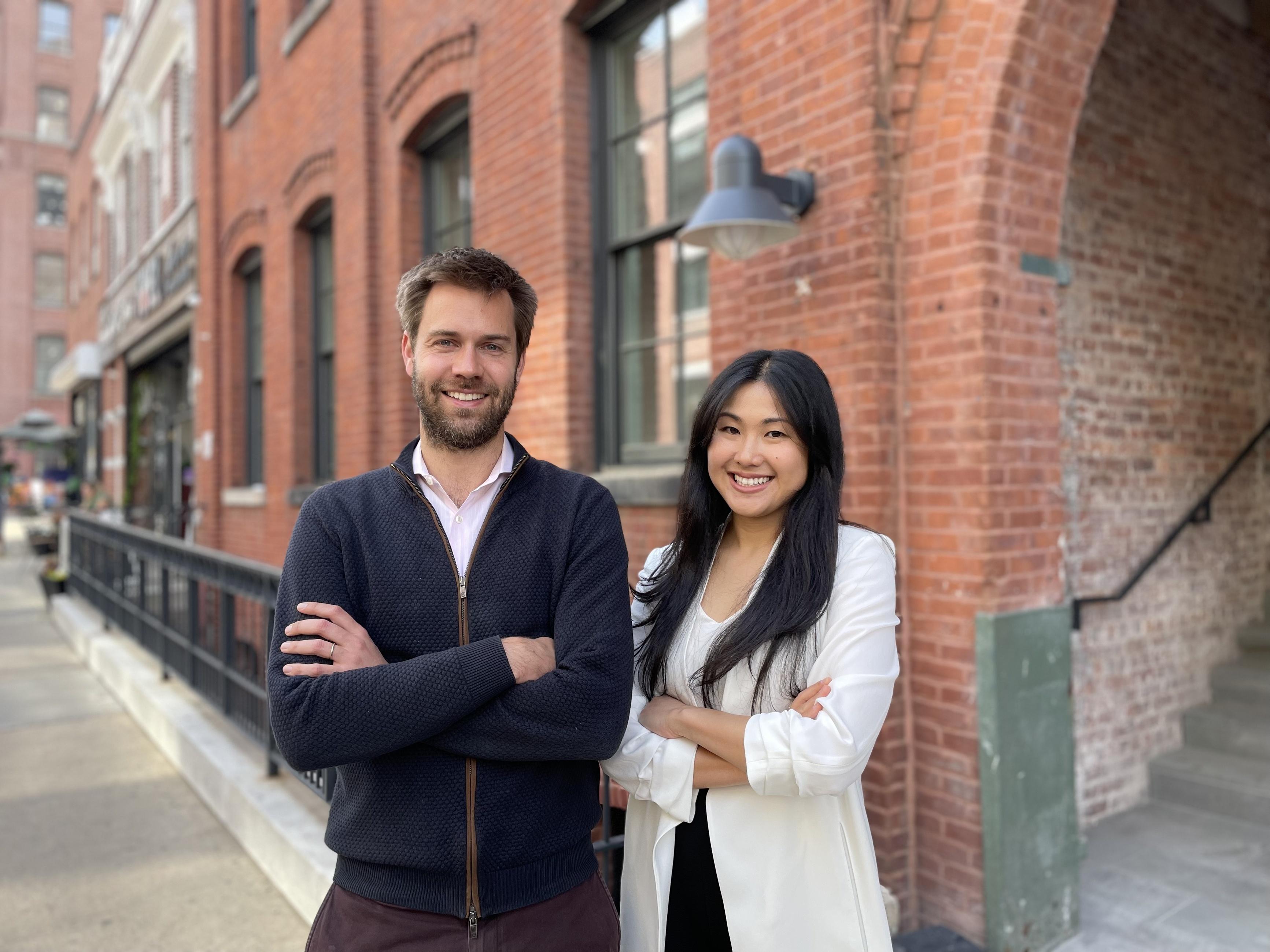 Bruno Van Tuykom and Amy Fan standing together outside a brick building