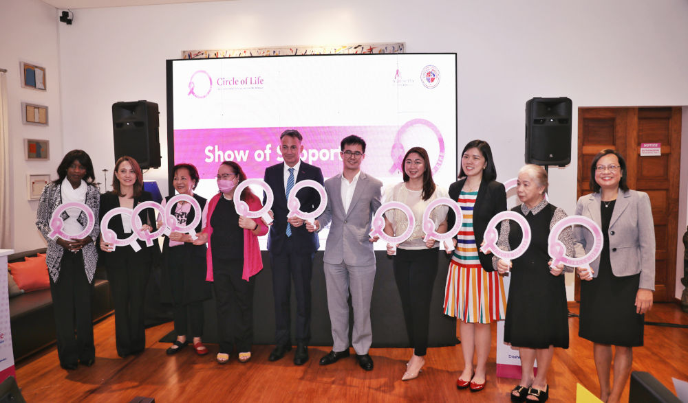 Bryan Giger, sixth from left, alongside partners at a 2023 gathering