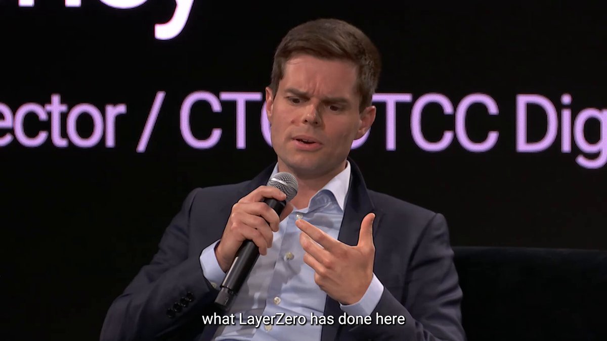 Bryan Pellegrino speaking into a microphone on stage