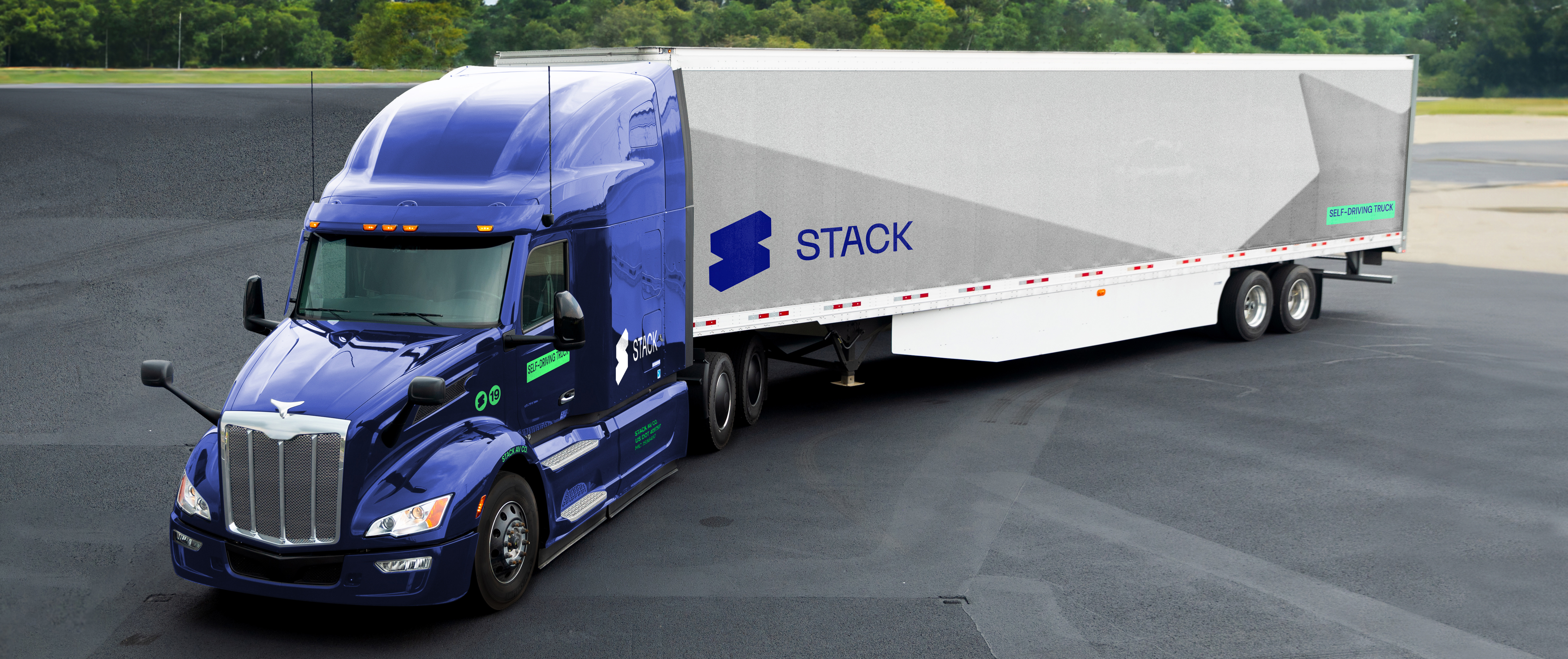 A Stack AV tractor-trailer photographed on a road