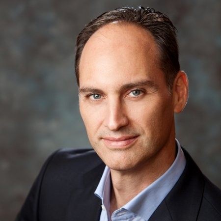 Bryon Thomas in a dark jacket and blue shirt