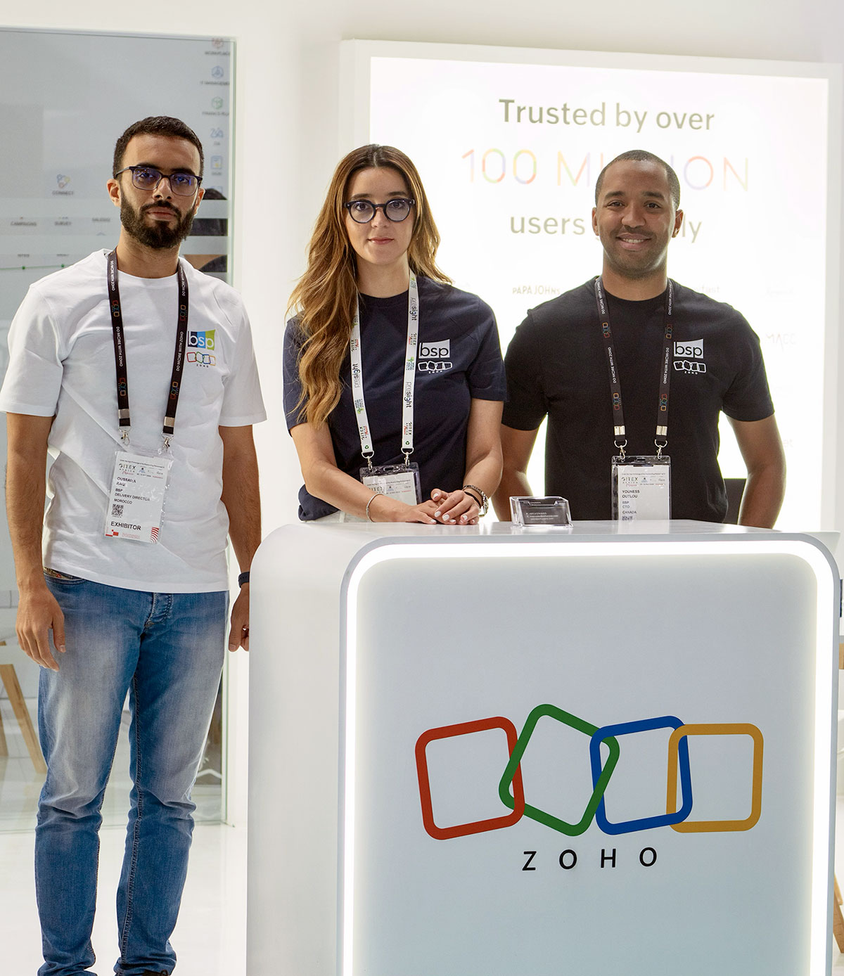 Three BSP team members at a Zoho event booth