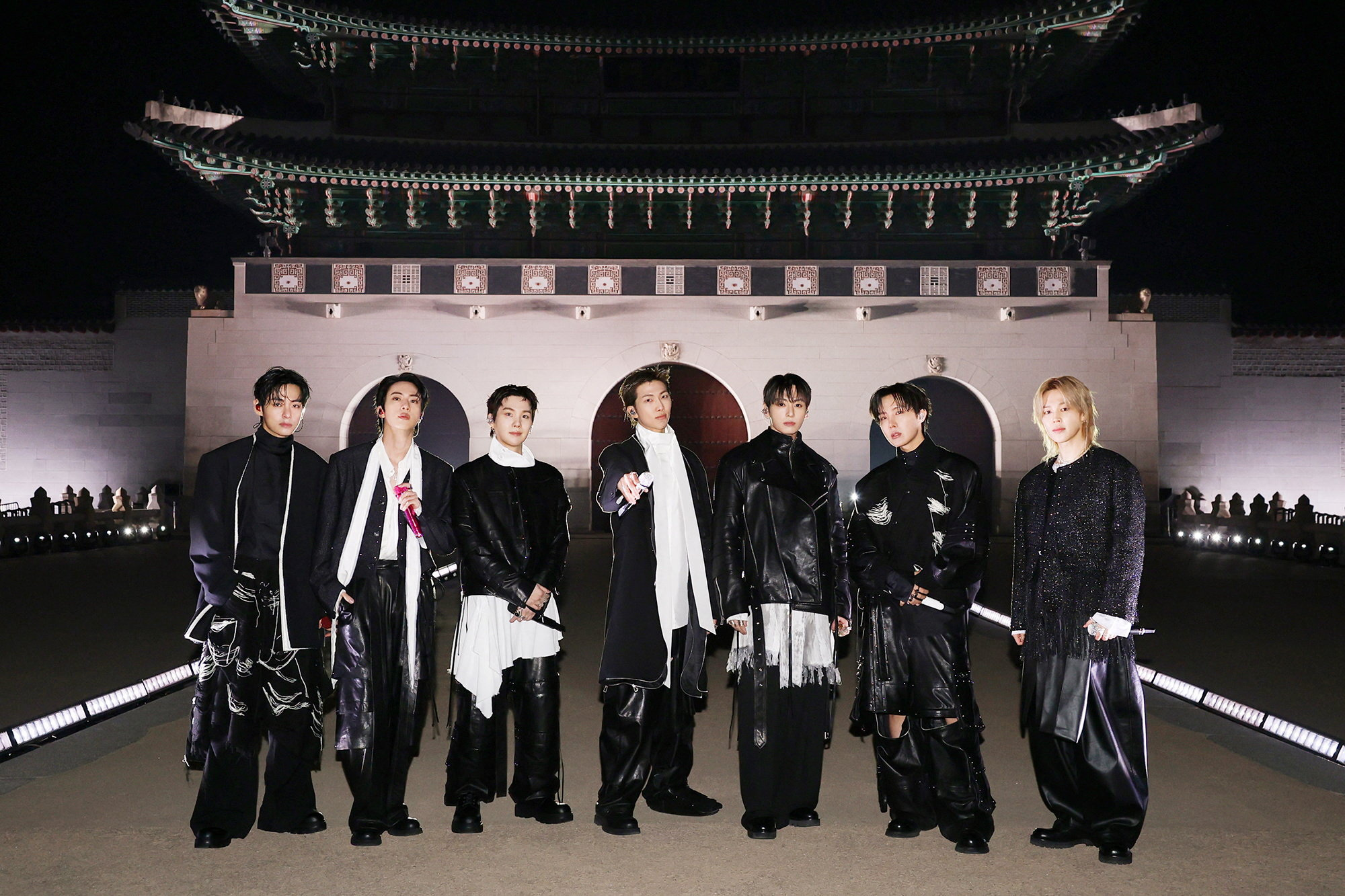 The seven members of BTS perform in black outfits before the illuminated Gwanghwamun gate in Seoul