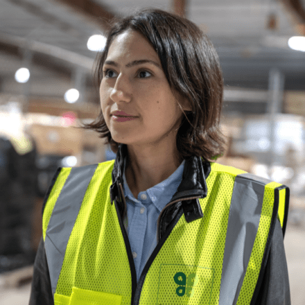 A Budderfly team member wearing a safety vest inside a facility