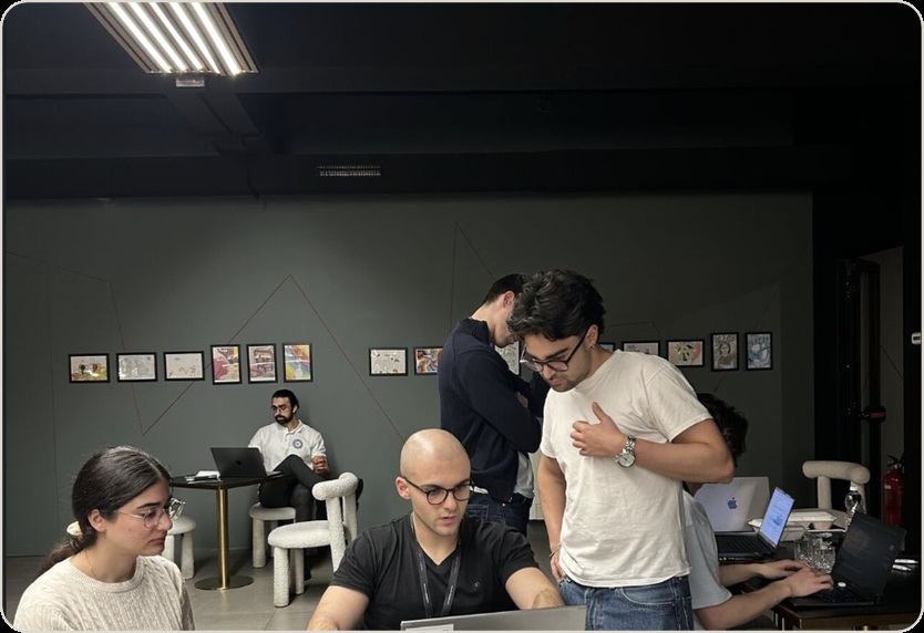 Build It Up hackathon participants collaborating around laptops
