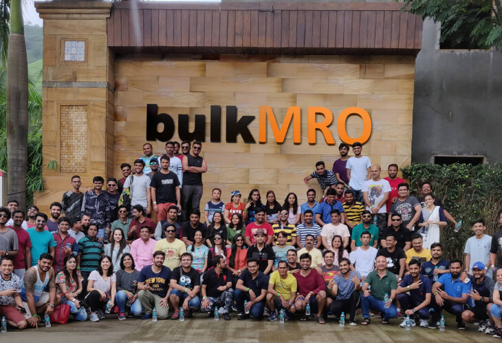 Bulk MRO team gathered outdoors in front of the company sign