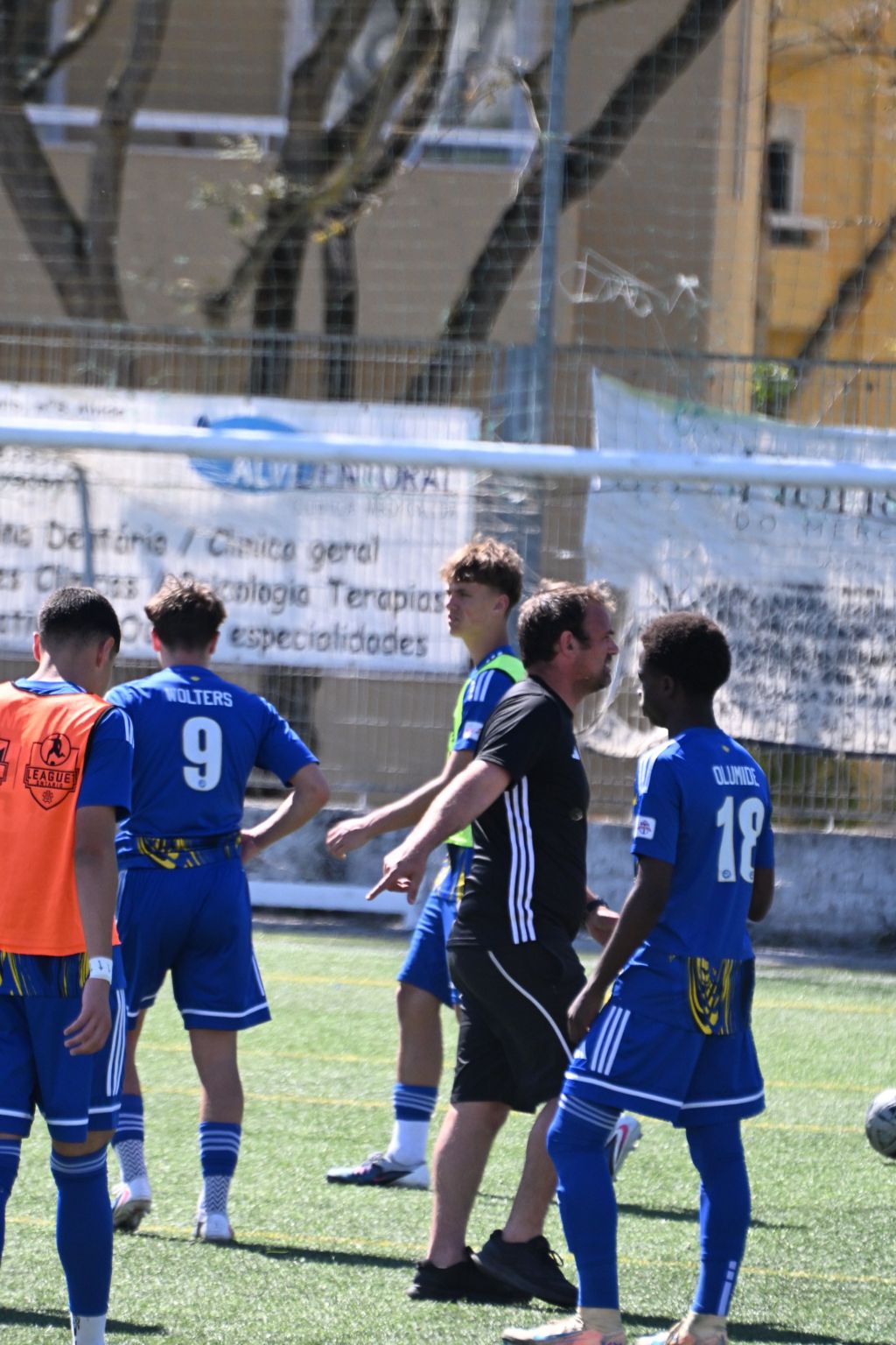Burlington Bayhawks players and a coach gathered beside the pitch