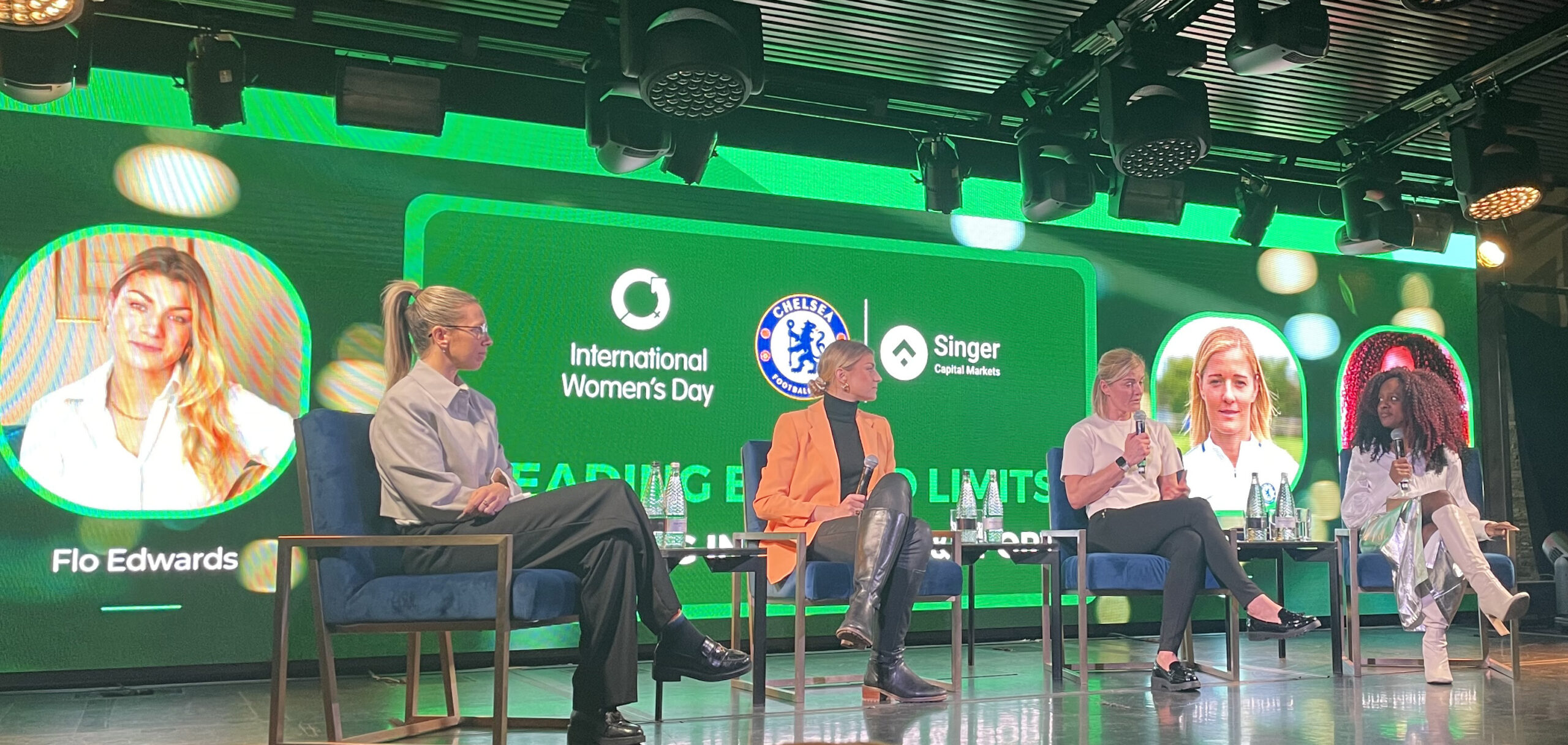Panelists on stage at an International Women's Day event hosted with Singer Capital Markets and Chelsea Football Club
