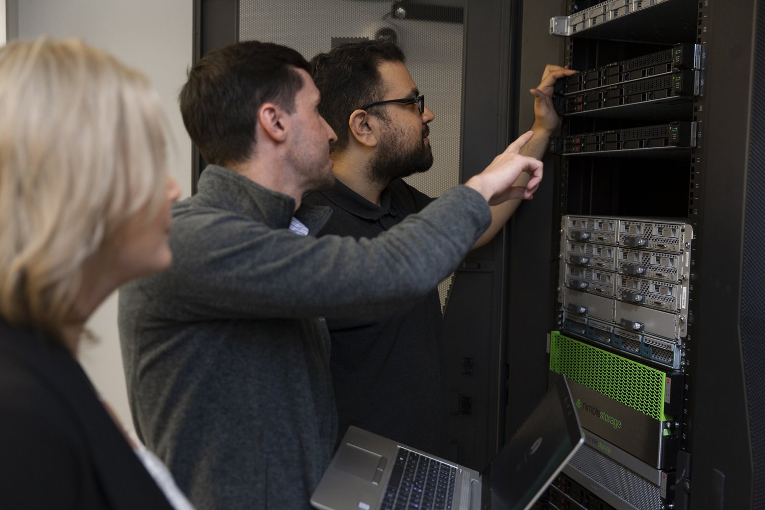 Burwood Group technologists inspecting equipment in a server rack