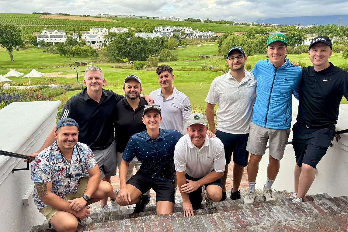 BVNK colleagues pose outdoors beside a golf course