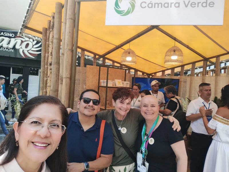 A group gathered at the Cámara Verde booth in Cali during COP16