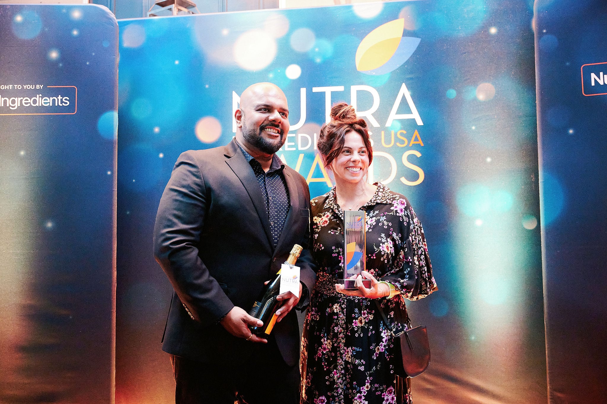 Vivek Lal at left beside a fellow attendee holding resbiotic’s trophy at the 2026 NutraIngredients USA Awards
